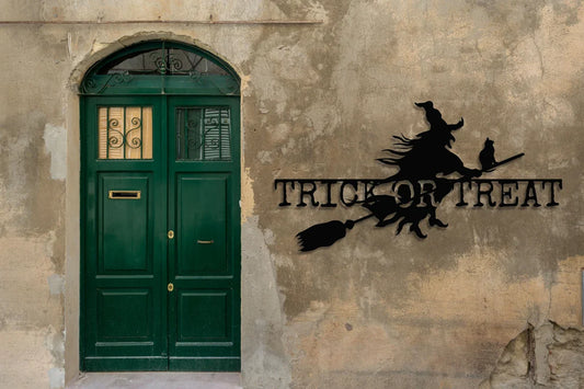 Halloween witch sign decoration with a green door and trick or treat theme.